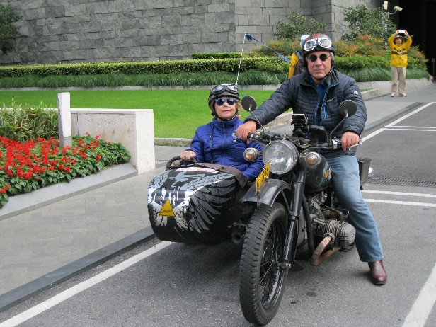 Barb riding a motorcycle in a sidecar